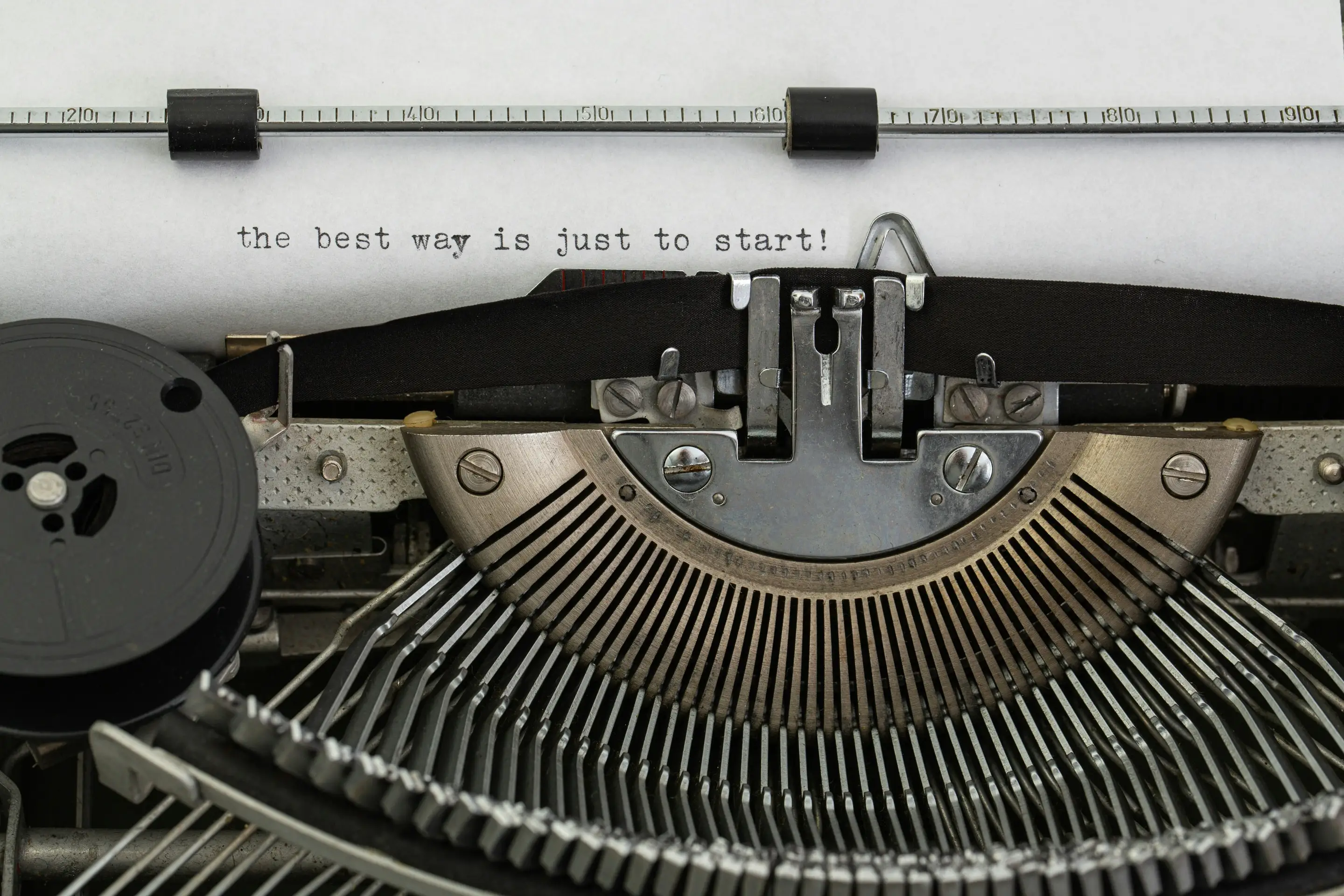 Typewriter with page of typed text reading: the best way is just to start.